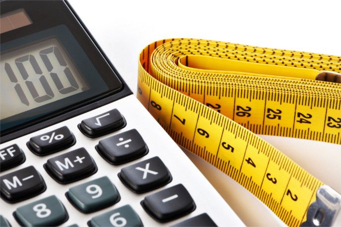 Centimeter and calculator isolated on white background