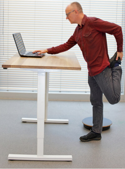 Man is standing in improper posture during standing office work