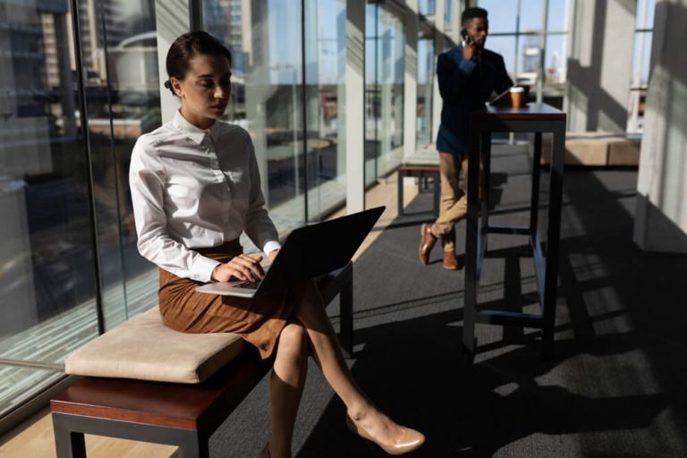 Office Employee is sitting on bench in modern office