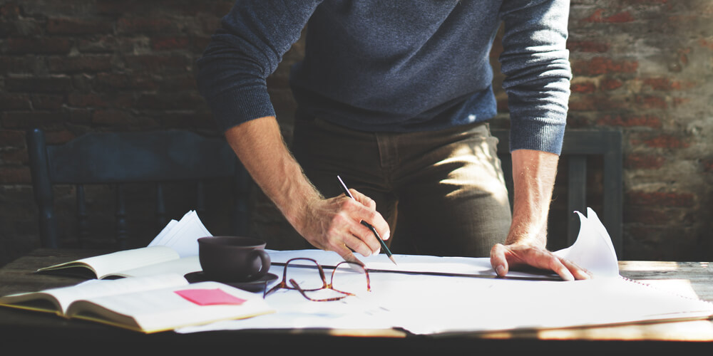 Man is creating a working schedule for himself