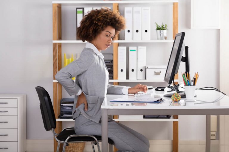 Young Businesswoman Suffering From Back Pain at work