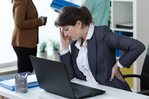 Young woman suffering from lower back pain