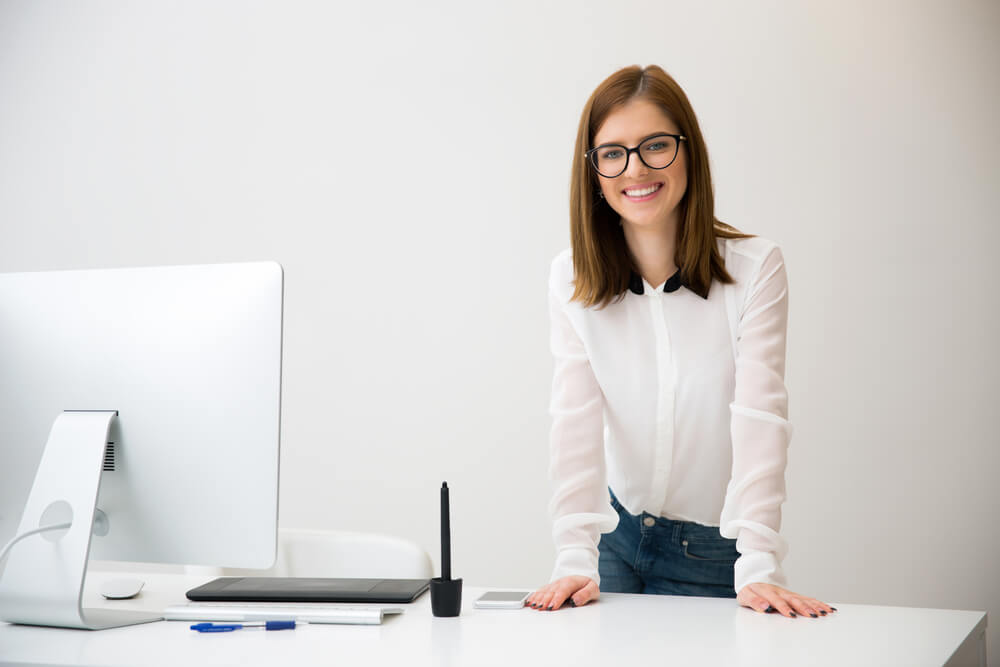 businesswoman is standing at her ergonomic workplace