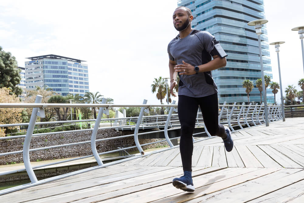 fit and sporty young man running in the city center