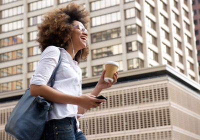 smiling African American woman walking in the city downtown