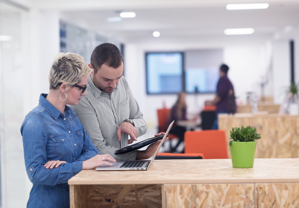 woman is working in standing pose in her office 