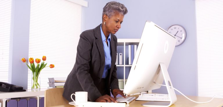 Senior African businesswoman working at desk