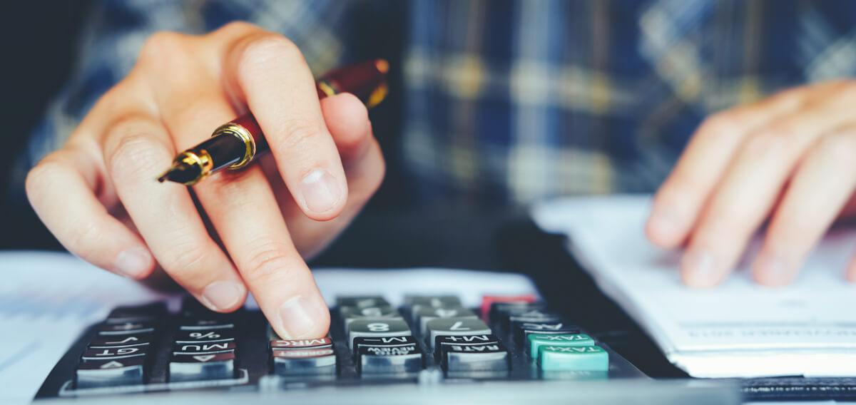 Businessman's hands with calculator at the office