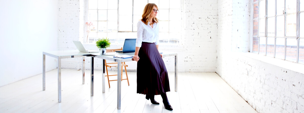 young businesswoman standing at office desk