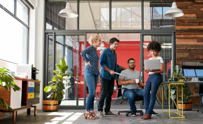 creative people having a meeting with a laptop in a modern office