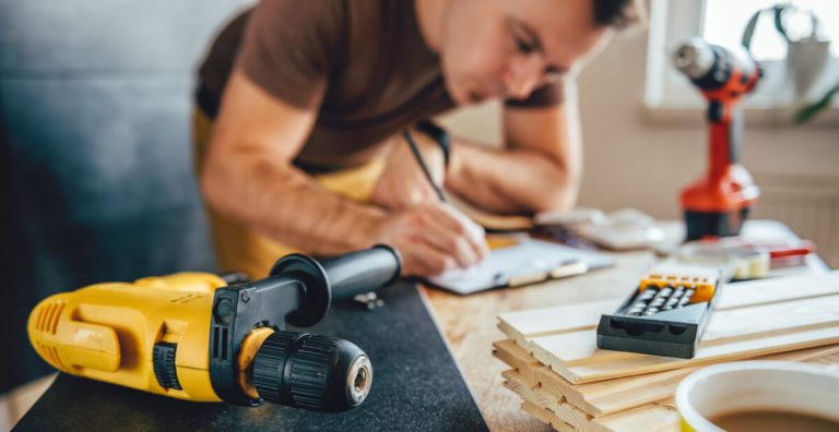 man making draft plan of sit-stand desk