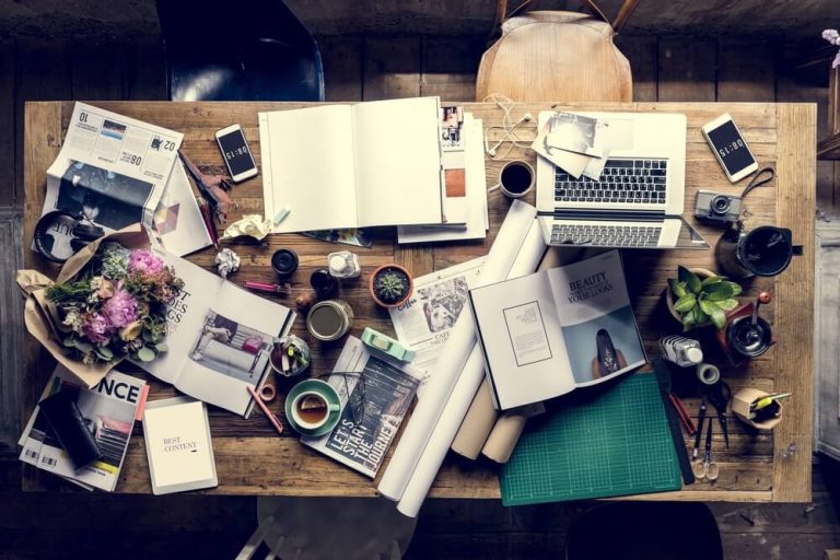 messy wooden standing desk workspace