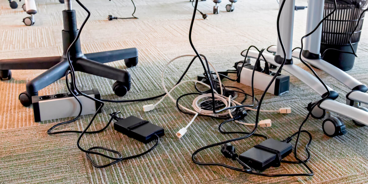 tangled electrical wires under the table